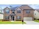 Charming two-story brick home with a well-manicured lawn and attached two-car garage at 2897 Austin Common Dr, Dacula, GA 30019