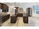 Spacious kitchen features granite countertops, dark wood cabinets, double islands, and stainless steel appliances at 2897 Austin Common Dr, Dacula, GA 30019
