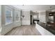 Bright kitchen with wood floors, a black countertop island, and natural light from a window at 2897 Austin Common Dr, Dacula, GA 30019