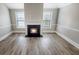 Cozy living room with wood floors and a fireplace, offering a warm and inviting atmosphere at 2897 Austin Common Dr, Dacula, GA 30019