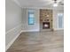 Bright living room showcasing a stone fireplace and luxury vinyl plank flooring at 2897 Austin Common Dr, Dacula, GA 30019
