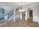 Open-concept living room with hardwood floors, arched doorways and a staircase at 2897 Austin Common Dr, Dacula, GA 30019