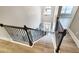 Elegant staircase with dark wood banister and luxury vinyl plank flooring on landing at 2897 Austin Common Dr, Dacula, GA 30019