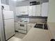 Functional kitchen with white appliances and ample cabinet space, offering a practical and efficient cooking area at 32 Peachtree Nw St # 705, Atlanta, GA 30303