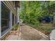 View from the side of the home looking towards the backyard with gravel path and some wooded landscaping at 3278 Winter Wood Ct, Marietta, GA 30062