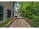 Exterior view from the side of the home with gravel walkway leading toward the back yard and a shed at 3278 Winter Wood Ct, Marietta, GA 30062