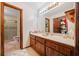 Bathroom featuring wood cabinetry, a large mirror, and a glass-enclosed shower at 3278 Winter Wood Ct, Marietta, GA 30062