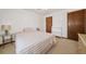 Clean bedroom featuring a full bed, side table, closet and a light colored carpet at 3278 Winter Wood Ct, Marietta, GA 30062