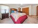 Comfortable bedroom featuring a wooden headboard, carpeted floor, dresser, and closet space at 3278 Winter Wood Ct, Marietta, GA 30062