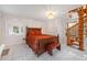 Bedroom featuring tile floor, a spiral staircase, and a queen bed in neutral tones at 3278 Winter Wood Ct, Marietta, GA 30062