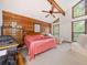 Bright bedroom with vaulted ceiling, ceiling fan, wood accent wall, and large windows at 3278 Winter Wood Ct, Marietta, GA 30062