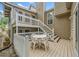 Back deck with white railings and stairs featuring a table and four chairs at 3278 Winter Wood Ct, Marietta, GA 30062