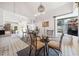 Bright dining area featuring a glass-top table, modern lighting, and seamless transition to the kitchen at 3278 Winter Wood Ct, Marietta, GA 30062