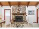 Cozy living room featuring a stone fireplace and wood beam ceiling at 3278 Winter Wood Ct, Marietta, GA 30062