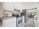 Well-lit kitchen boasts stainless steel appliances, white cabinetry and an adjacent dining area at 3278 Winter Wood Ct, Marietta, GA 30062