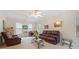 Bright living room featuring a ceiling fan, plush leather seating, and natural light, offering a cozy space at 3278 Winter Wood Ct, Marietta, GA 30062