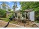 Exterior view of a shed with an open door and small sliding glass doors with plants decorating a nearby table at 3278 Winter Wood Ct, Marietta, GA 30062