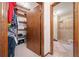 Walk-in closet adjacent to a bathroom with built-in shelving at 3278 Winter Wood Ct, Marietta, GA 30062