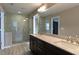 Modern bathroom boasts dual vanities, large mirrors, and tiled walk-in shower at 257 Stone Park Dr, Woodstock, GA 30188