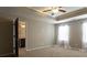 Well-lit bedroom featuring tray ceilings and a relaxing neutral color palette at 257 Stone Park Dr, Woodstock, GA 30188