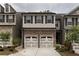 Charming townhome with stone accents, two-car garage, and neutral color palette at 257 Stone Park Dr, Woodstock, GA 30188