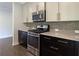 Beautiful kitchen features granite countertops, modern appliances, and tile backsplash at 257 Stone Park Dr, Woodstock, GA 30188