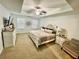 Luxurious primary bedroom with tray ceiling, and comfortable design at 257 Stone Park Dr, Woodstock, GA 30188