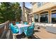 Back deck with dining and lounge area, with views of the lush backyard and a large brick house with arched windows at 2770 Wooded Hills Walk, Marietta, GA 30062
