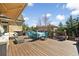 Spacious back deck featuring outdoor furniture, a dining table, and a relaxing lounge area, surrounded by trees at 2770 Wooded Hills Walk, Marietta, GA 30062