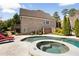 Beautiful backyard with a pool and hot tub surrounded by a patio, mature landscaping, and lounge chairs at 2770 Wooded Hills Walk, Marietta, GA 30062