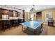 Basement featuring a wet bar with stone countertop, dark wood cabinetry, and a game table at 2770 Wooded Hills Walk, Marietta, GA 30062