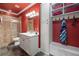 Red themed bathroom with a glass shower, double sink, built in shelving, and towel hooks at 2770 Wooded Hills Walk, Marietta, GA 30062