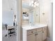 Bright bathroom featuring a large mirror, white vanity, neutral walls, and views into an adjacent bedroom and closet at 2770 Wooded Hills Walk, Marietta, GA 30062