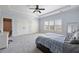 Spacious bedroom with light blue walls, tray ceiling, a ceiling fan and wide window with wooden shutters at 2770 Wooded Hills Walk, Marietta, GA 30062