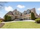 Stately brick home with manicured lawn, three-car garage and inviting entryway at 2770 Wooded Hills Walk, Marietta, GA 30062