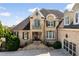 Elegant brick home featuring upper level balcony and a well-manicured front yard at 2770 Wooded Hills Walk, Marietta, GA 30062