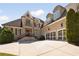 Elegant brick home with a three-car garage, landscaped yard, and inviting entrance at 2770 Wooded Hills Walk, Marietta, GA 30062