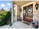 Charming front porch featuring double doors with decorative ironwork, brick columns, and tasteful landscaping at 2770 Wooded Hills Walk, Marietta, GA 30062