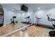 Bright home gym with mirrored wall, TV, wood flooring, and modern exercise equipment at 2770 Wooded Hills Walk, Marietta, GA 30062