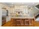 Well-appointed kitchen with a granite island, stainless steel appliances, custom cabinetry, and hardwood flooring at 2770 Wooded Hills Walk, Marietta, GA 30062