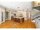Spacious kitchen featuring a large island with seating, stainless steel appliances, and beautiful hardwood floors at 2770 Wooded Hills Walk, Marietta, GA 30062