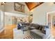 Open living space with hardwood floors, neutral sectional sofa, decorative rug, and kitchen view, perfect for entertaining at 2770 Wooded Hills Walk, Marietta, GA 30062