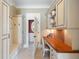 Convenient mud room with a built-in desk, storage cabinets, and coat hooks at 2770 Wooded Hills Walk, Marietta, GA 30062