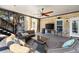 Covered outdoor patio area with comfortable wicker seating, ceiling fan, and mounted television at 2770 Wooded Hills Walk, Marietta, GA 30062