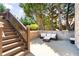 Outdoor patio with wicker seating and stairs leading to the upper deck and backyard at 2770 Wooded Hills Walk, Marietta, GA 30062