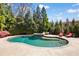Beautiful backyard pool with mature landscaping and an inviting lounge area, perfect for relaxing and entertaining at 2770 Wooded Hills Walk, Marietta, GA 30062