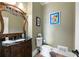Elegant powder room featuring a marble countertop and classic fixtures at 2770 Wooded Hills Walk, Marietta, GA 30062