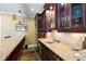 Granite countertop with dark wood cabinets including glass door display cabinets above at 2770 Wooded Hills Walk, Marietta, GA 30062