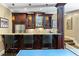 Wet bar featuring dark wood cabinets with granite countertops and barstool seating at 2770 Wooded Hills Walk, Marietta, GA 30062