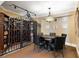 Wine cellar with a gated wine rack and a round table and chairs under a chandelier at 2770 Wooded Hills Walk, Marietta, GA 30062